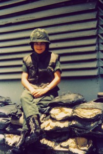 Mary little on bags of sand in uniform